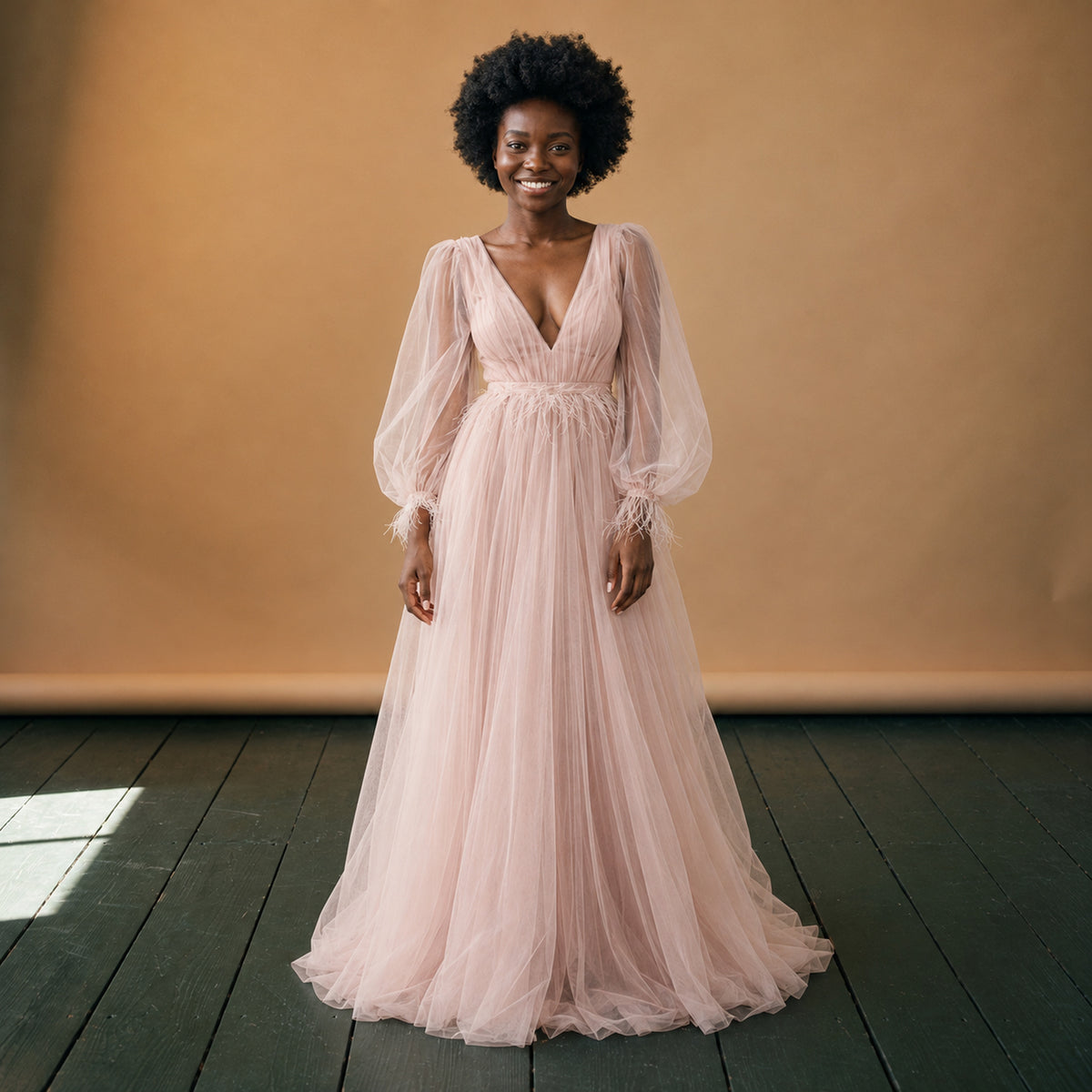 Robe charleston mariage à manches longues rose poudré portée en studio, vue de face Bild