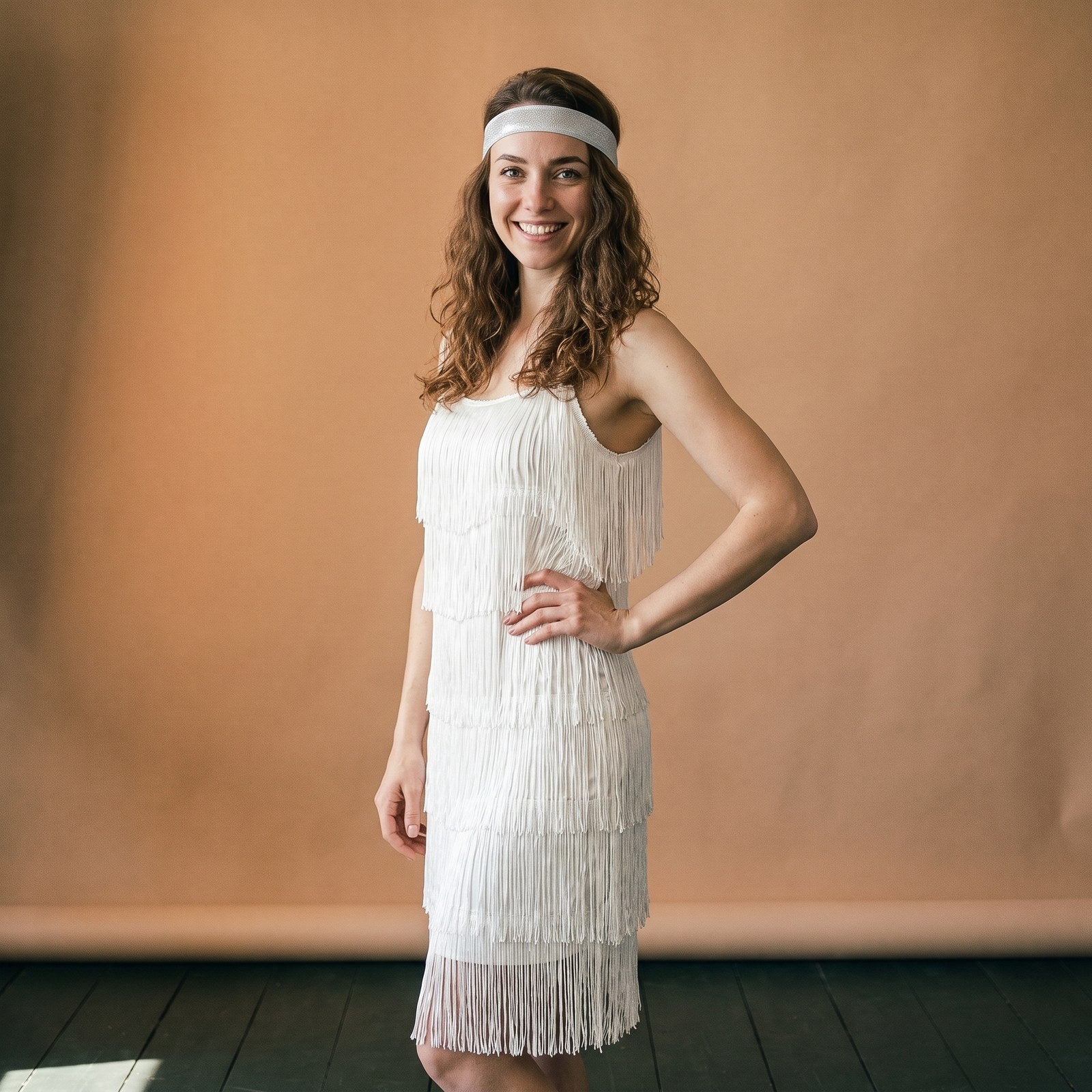 Mannequin en robe charleston blanche à franges avec bandeau des années folles Bild